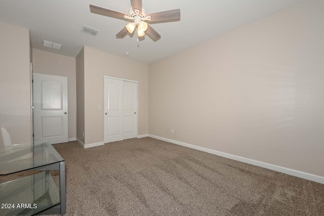 unfurnished bedroom with visible vents, baseboards, carpet, and a ceiling fan