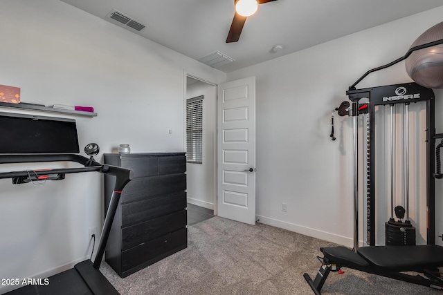 workout area featuring ceiling fan and light colored carpet