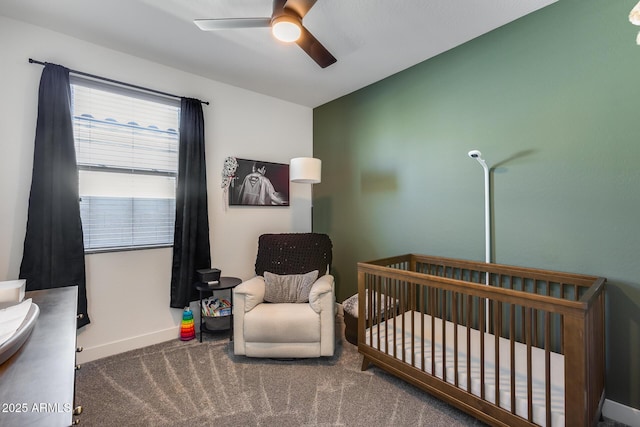 bedroom featuring ceiling fan, carpet, and a crib