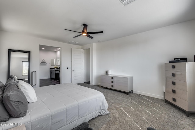 bedroom with ceiling fan, connected bathroom, and dark carpet