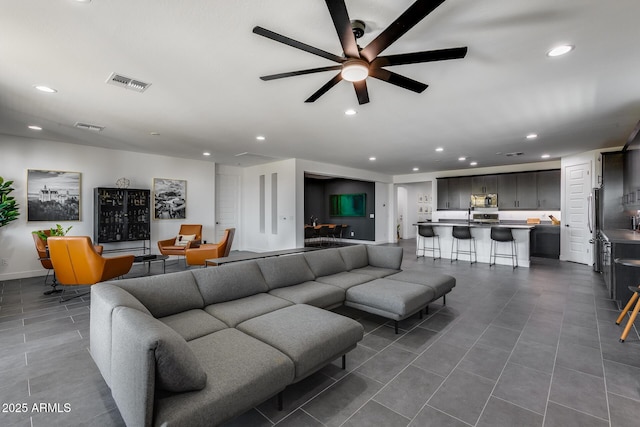 tiled living room featuring ceiling fan