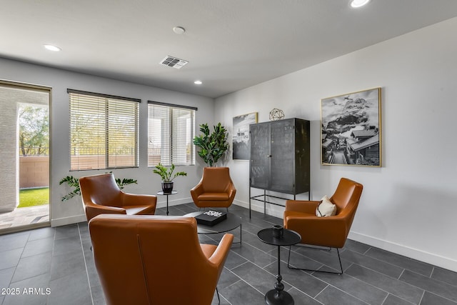 sitting room with dark tile patterned floors