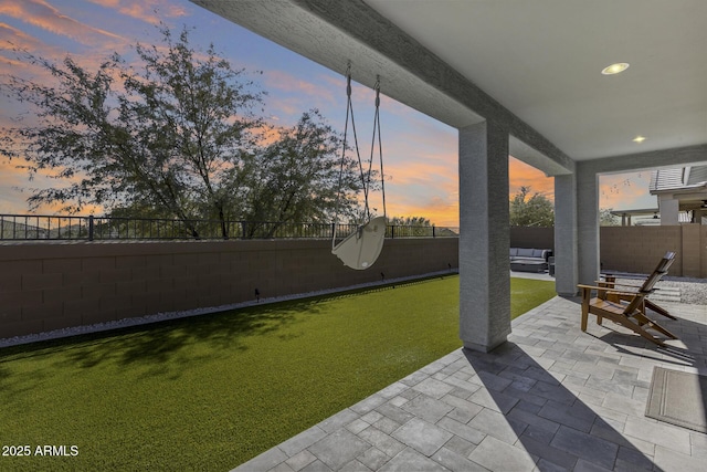 yard at dusk with a patio and an outdoor hangout area