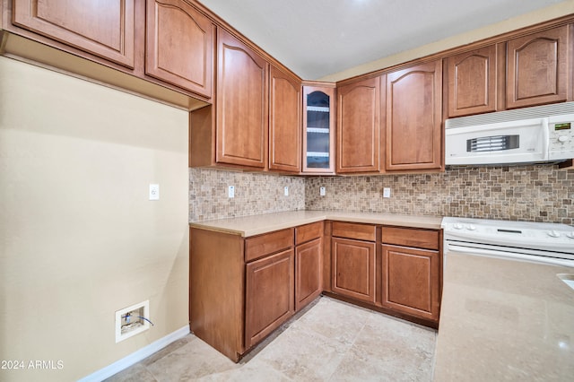 kitchen with white appliances and decorative backsplash