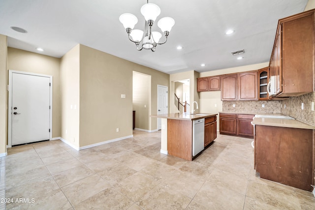 kitchen featuring backsplash, pendant lighting, an inviting chandelier, white appliances, and a kitchen island with sink