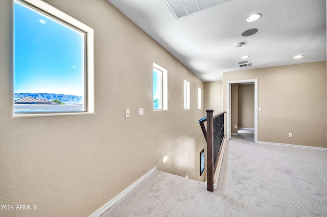 staircase featuring carpet and plenty of natural light