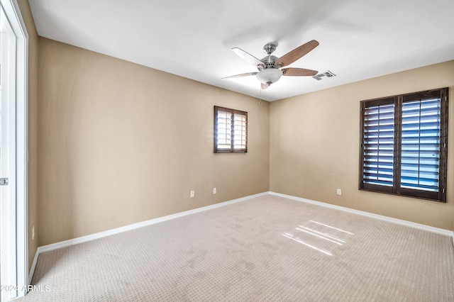 spare room with ceiling fan and carpet flooring