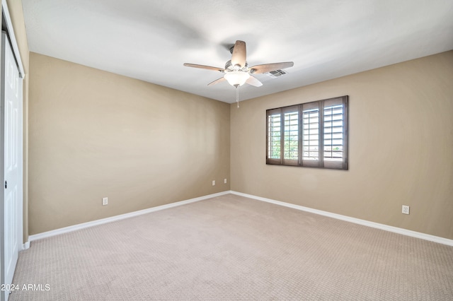 spare room featuring carpet and ceiling fan