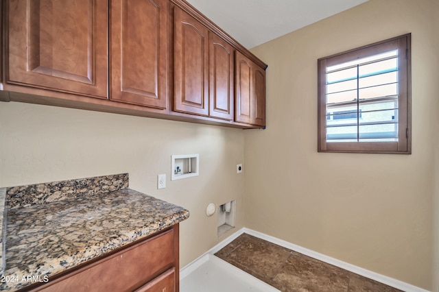 clothes washing area featuring hookup for a washing machine, electric dryer hookup, and cabinets