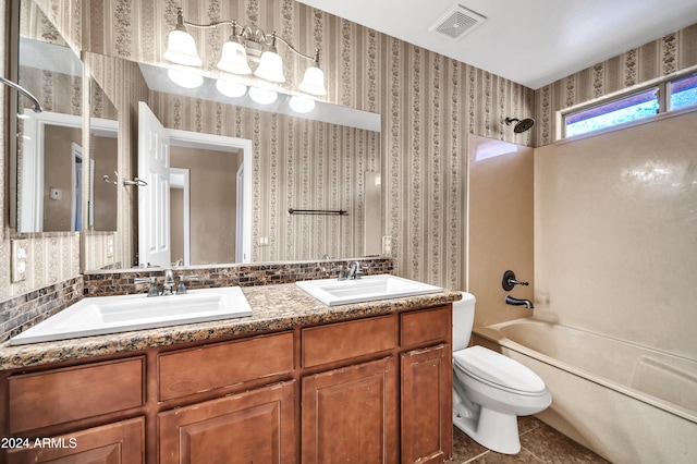 full bathroom featuring toilet, vanity, tile patterned flooring, and bathing tub / shower combination