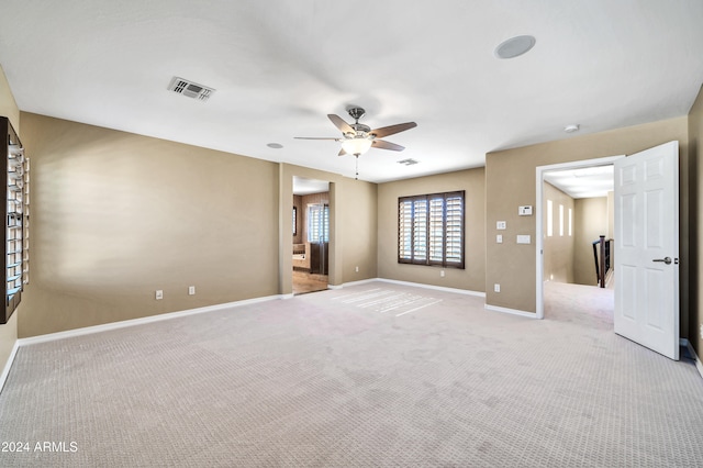 carpeted empty room featuring ceiling fan