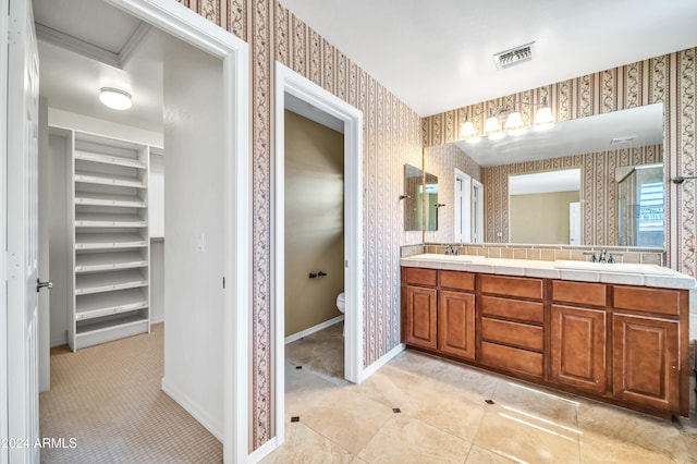 bathroom featuring tile patterned floors, vanity, and toilet