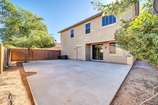 rear view of property featuring central air condition unit and a patio area