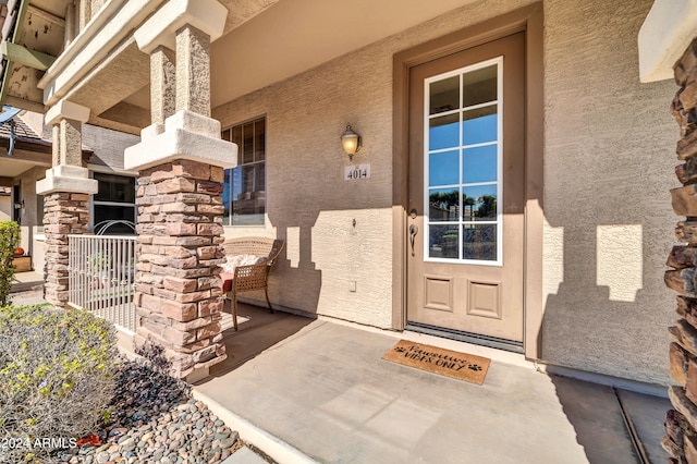 entrance to property featuring covered porch