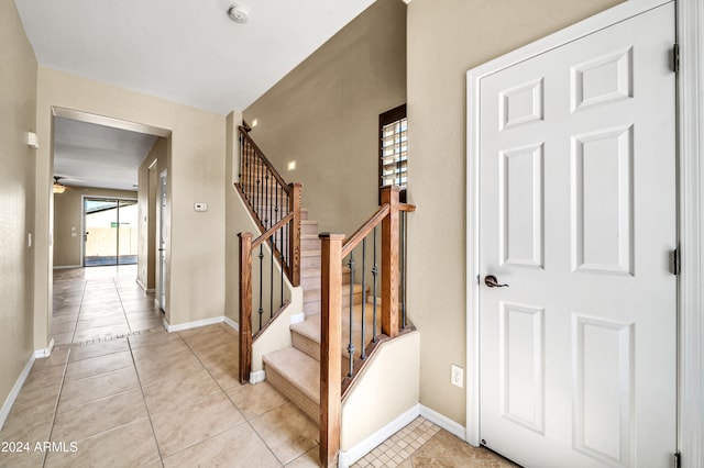 entrance foyer with ceiling fan and light tile patterned floors