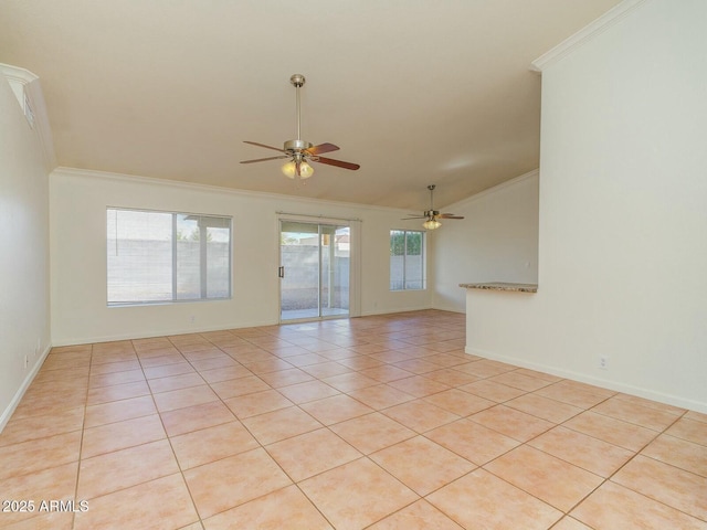 unfurnished room featuring crown molding, baseboards, vaulted ceiling, light tile patterned floors, and a ceiling fan