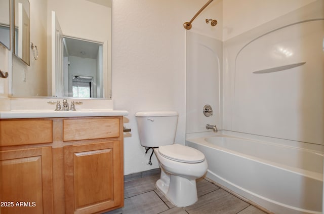 bathroom with vanity, shower / bathtub combination, and toilet