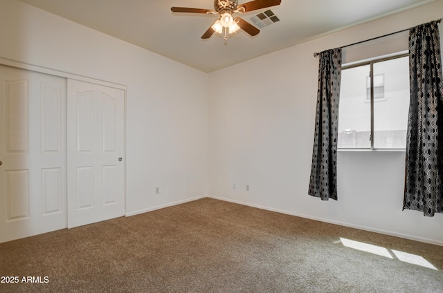 unfurnished bedroom with carpet floors, baseboards, a closet, and visible vents