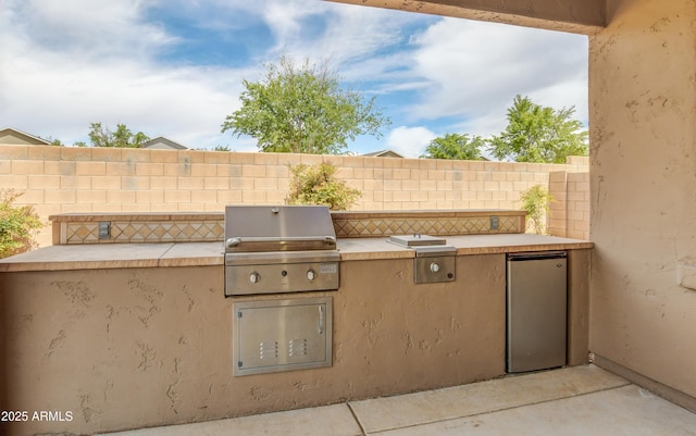 view of patio / terrace with fence, grilling area, and area for grilling