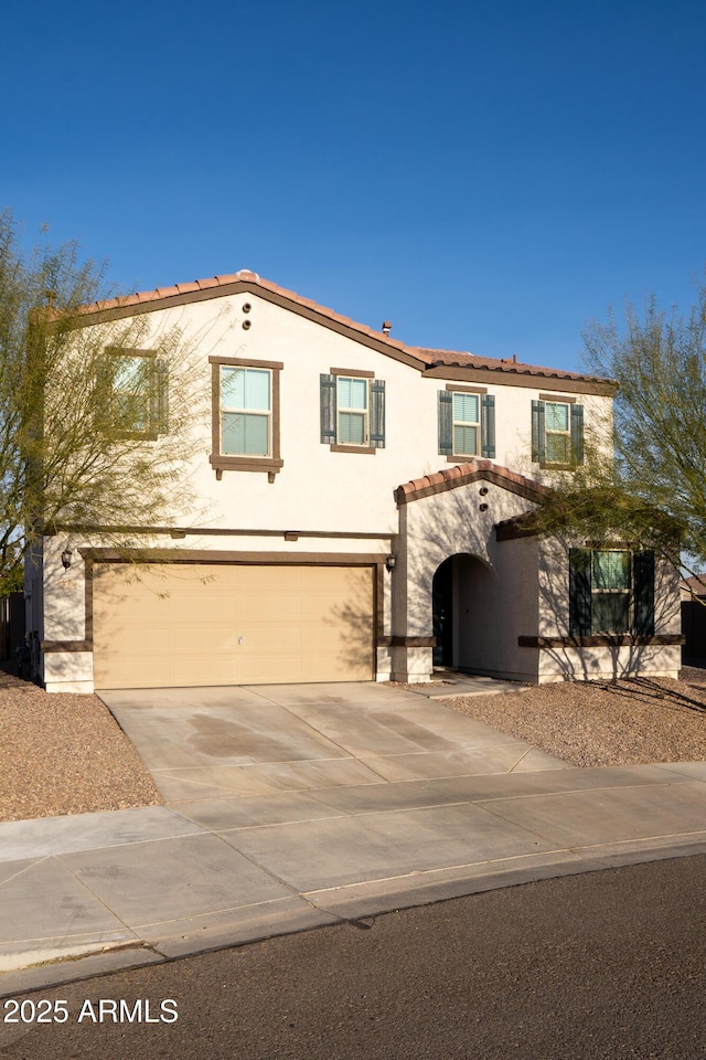 mediterranean / spanish-style home featuring a garage