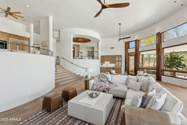 11334 E Troon Vista Dr, Scottsdale, AZ 85255 - living area featuring a high ceiling, a ceiling fan, wood finished floors, and stairs