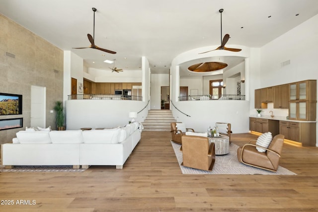 11334 E Troon Vista Dr, Scottsdale, AZ 85255 - living area with light wood-type flooring, a ceiling fan, and a high ceiling