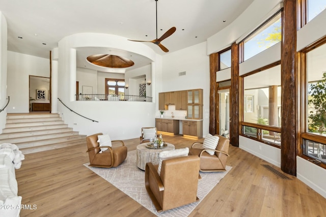 11334 E Troon Vista Dr, Scottsdale, AZ 85255 - living area with a towering ceiling, visible vents, light wood-style floors, and ceiling fan