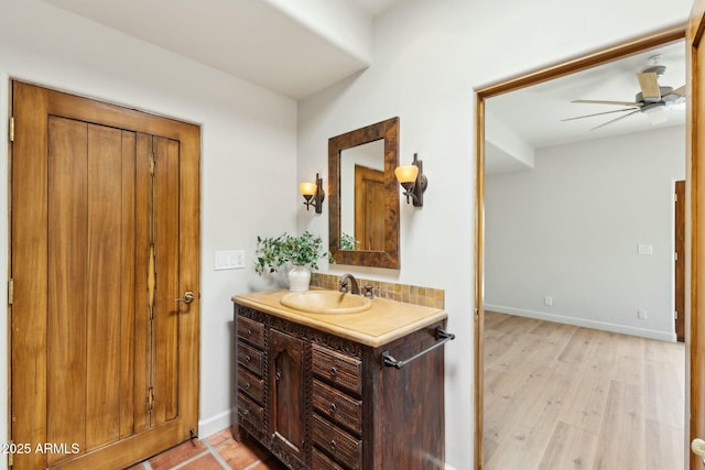 11334 E Troon Vista Dr, Scottsdale, AZ 85255 - bathroom with baseboards, wood finished floors, vanity, and ceiling fan