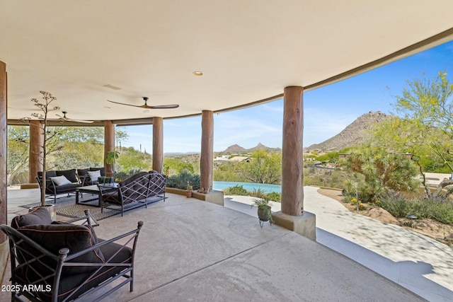 11334 E Troon Vista Dr, Scottsdale, AZ 85255 - view of patio / terrace featuring ceiling fan, an outdoor hangout area, and a mountain view