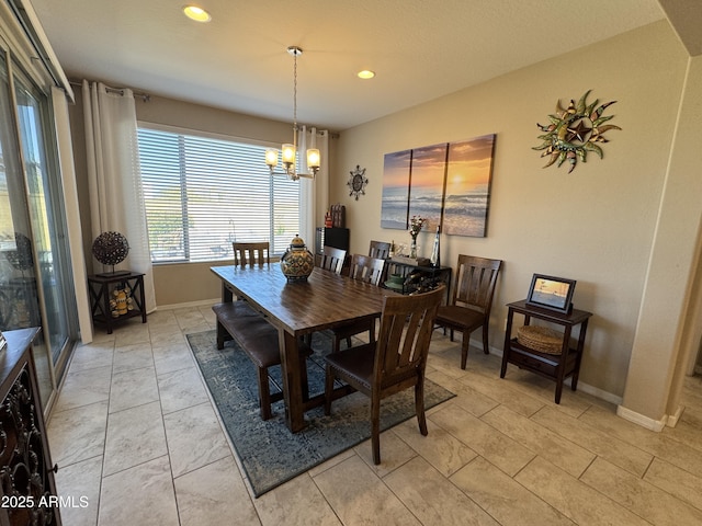 tiled dining area featuring a chandelier