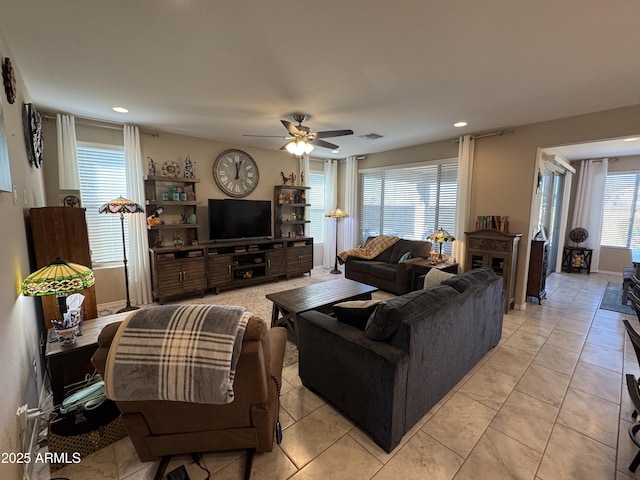 tiled living room with ceiling fan