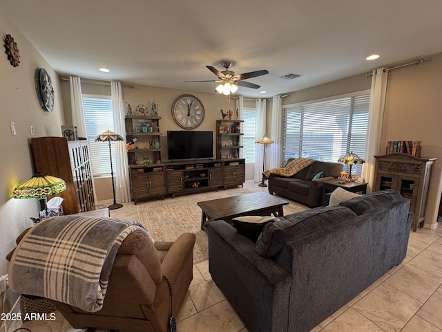 tiled living room with ceiling fan