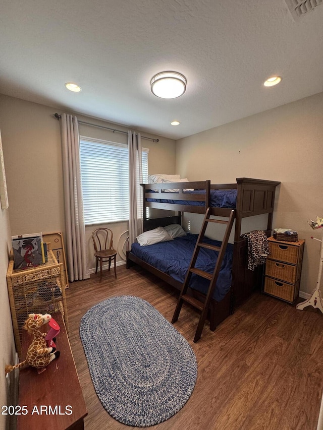 bedroom with dark wood-type flooring