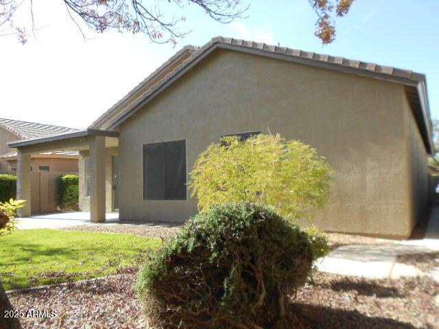 rear view of property with a lawn and a patio