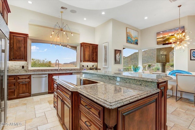 kitchen featuring stone tile flooring, a sink, a notable chandelier, and dishwasher