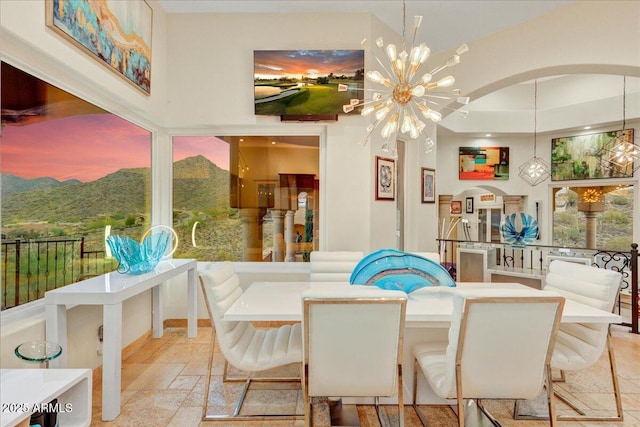 dining room with a chandelier and stone tile flooring