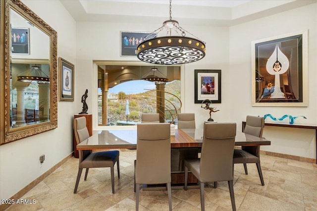 dining area featuring stone finish flooring and baseboards