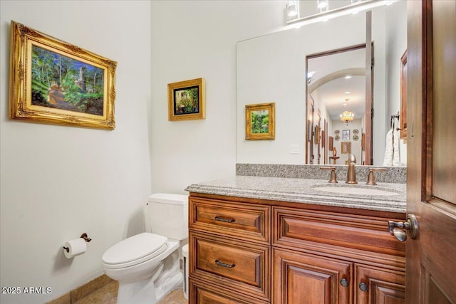 half bathroom with toilet and vanity