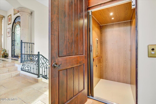 interior space with elevator, decorative columns, and recessed lighting