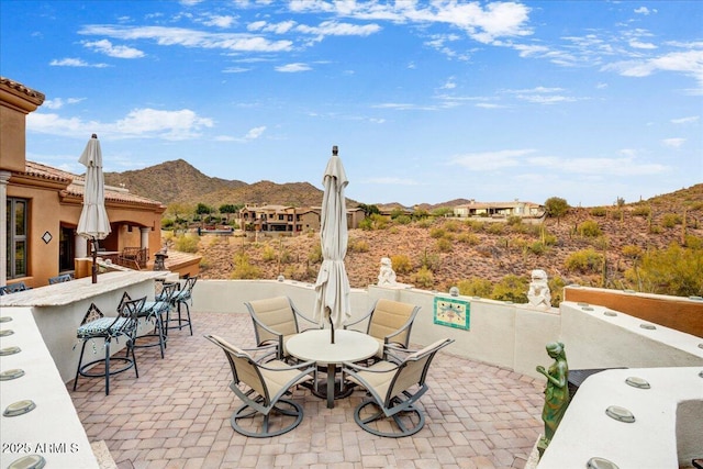 view of patio / terrace with a mountain view, outdoor dry bar, and outdoor dining space