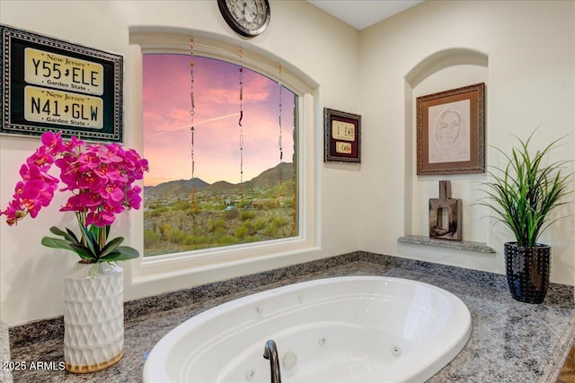 bathroom with a tub with jets