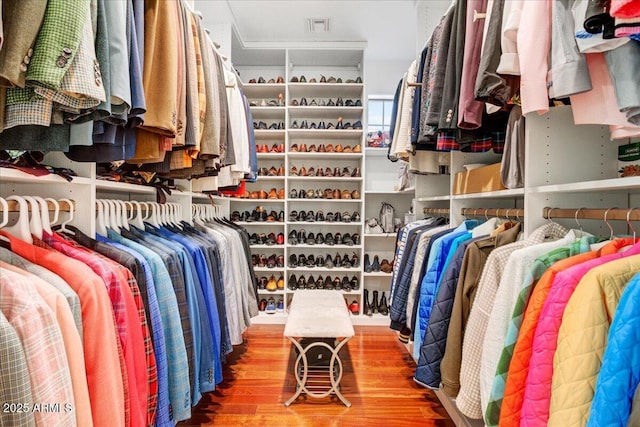 walk in closet with visible vents and wood finished floors