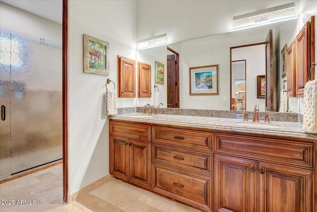 bathroom featuring a stall shower, a sink, baseboards, and double vanity