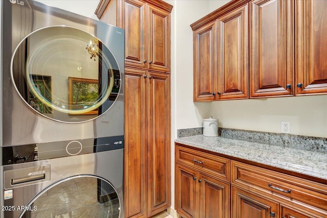 interior space with stacked washer and clothes dryer and cabinet space