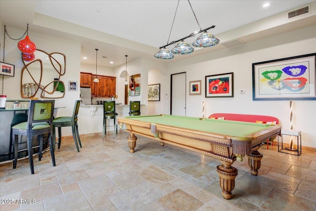 game room with arched walkways, stone tile floors, recessed lighting, visible vents, and baseboards