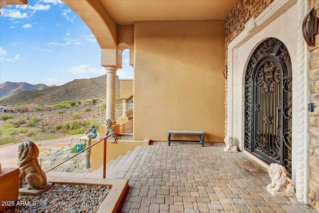 entrance to property with a mountain view and stucco siding