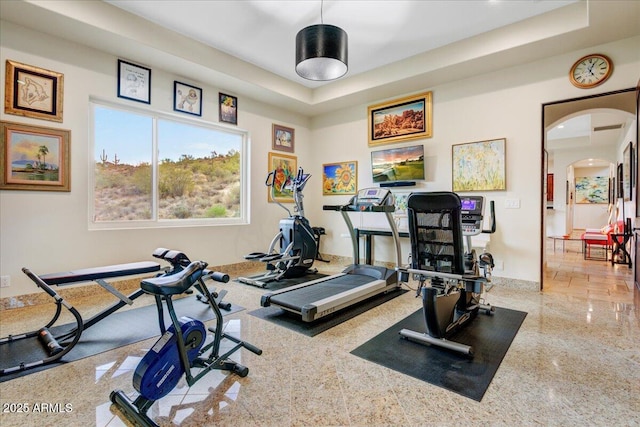 exercise room featuring arched walkways