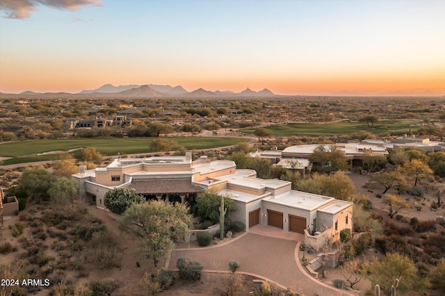 aerial view at dusk featuring a mountain view