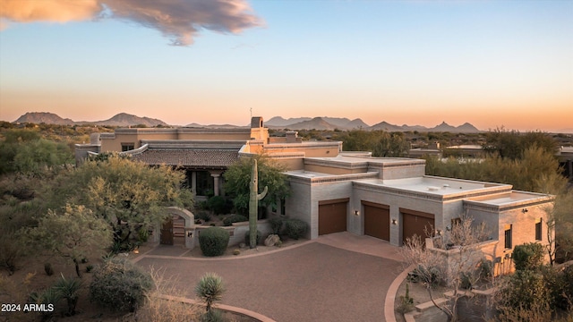 view of front of home with a mountain view and a garage