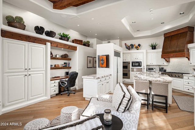 kitchen featuring white cabinets, light hardwood / wood-style flooring, and a kitchen island